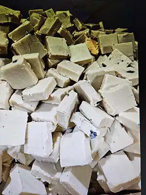 Photo looking down into a cardboard pallet box with new, unlabeled soap inside.