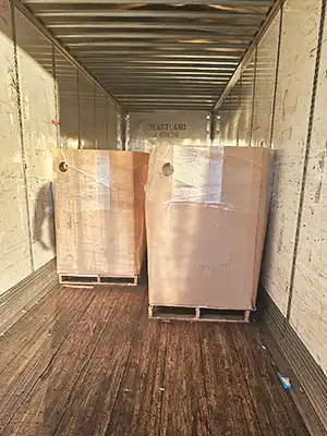 Photo of cardboard pallet boxes of soap inside a big rig semitrailer.